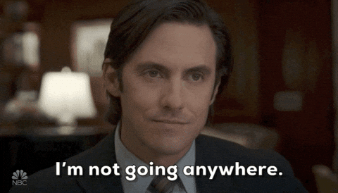 Animated GIF of a man smiling softly and looking reassuring, with the caption: "I'm not going anywhere."
